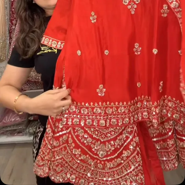 Close-up of a red hem with gold embroidery